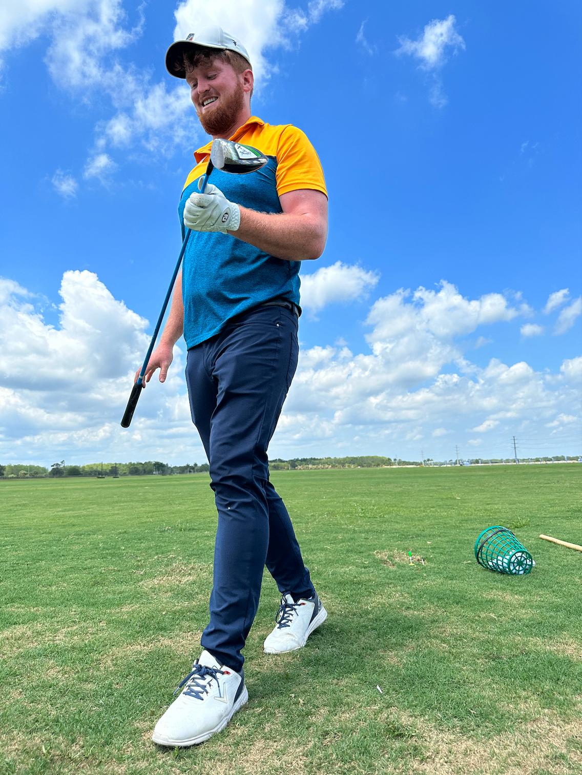 Stephen Hopper inspecting his driver after a shot on the range